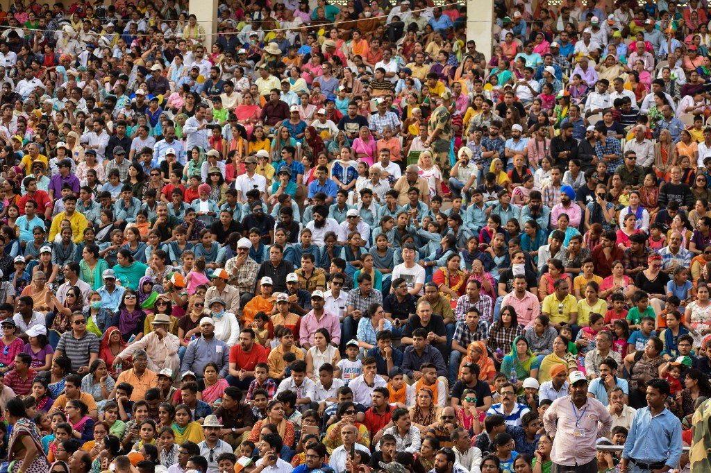 A densely packed crowd seated in tiered rows at an outdoor event — the kind of shoulder-to-shoulder gathering where pickpockets thrive.